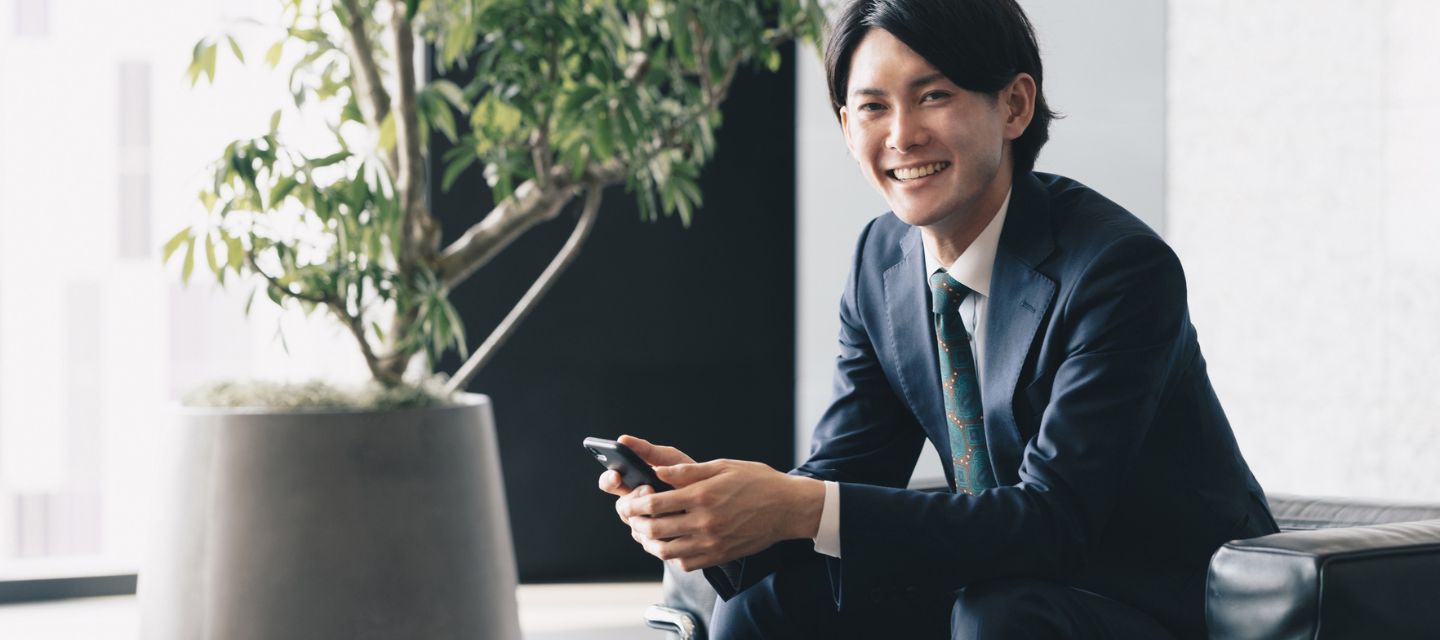 机で手を組むスーツ姿の男性